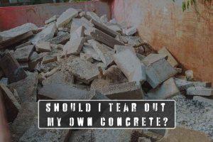 photo of a dumpster full of concrete debris - Should I Tear out My Own Concrete?