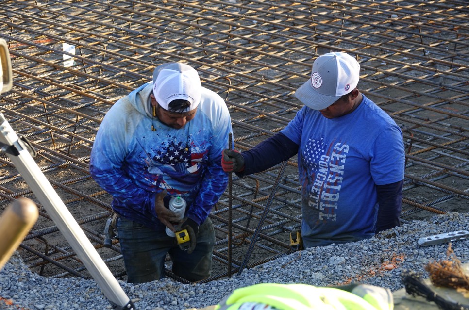 Professional concrete crew pouring an engineered slab with rebar reinforcement in Sevierville, TN.